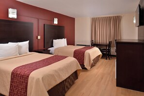 A hotel room with two beds, a desk, a chair, and a television. - Red Roof Inn Van Horn (Van Horn)
