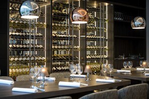 A restaurant with multiple tables set for dining, each with wine glasses and cutlery. - NH Bussum Jan Tabak (Bussum)