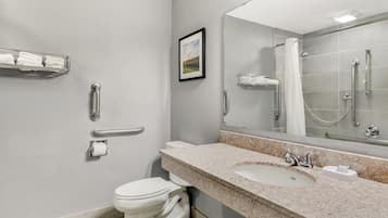 A modern bathroom with a toilet, sink, and shower.