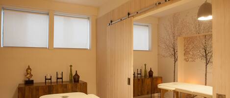 A modern room with a bed, a wooden cabinet, and a mirror.
