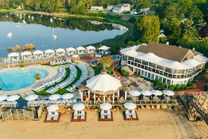 A resort with a swimming pool, beach area, and a large building with a dome structure.