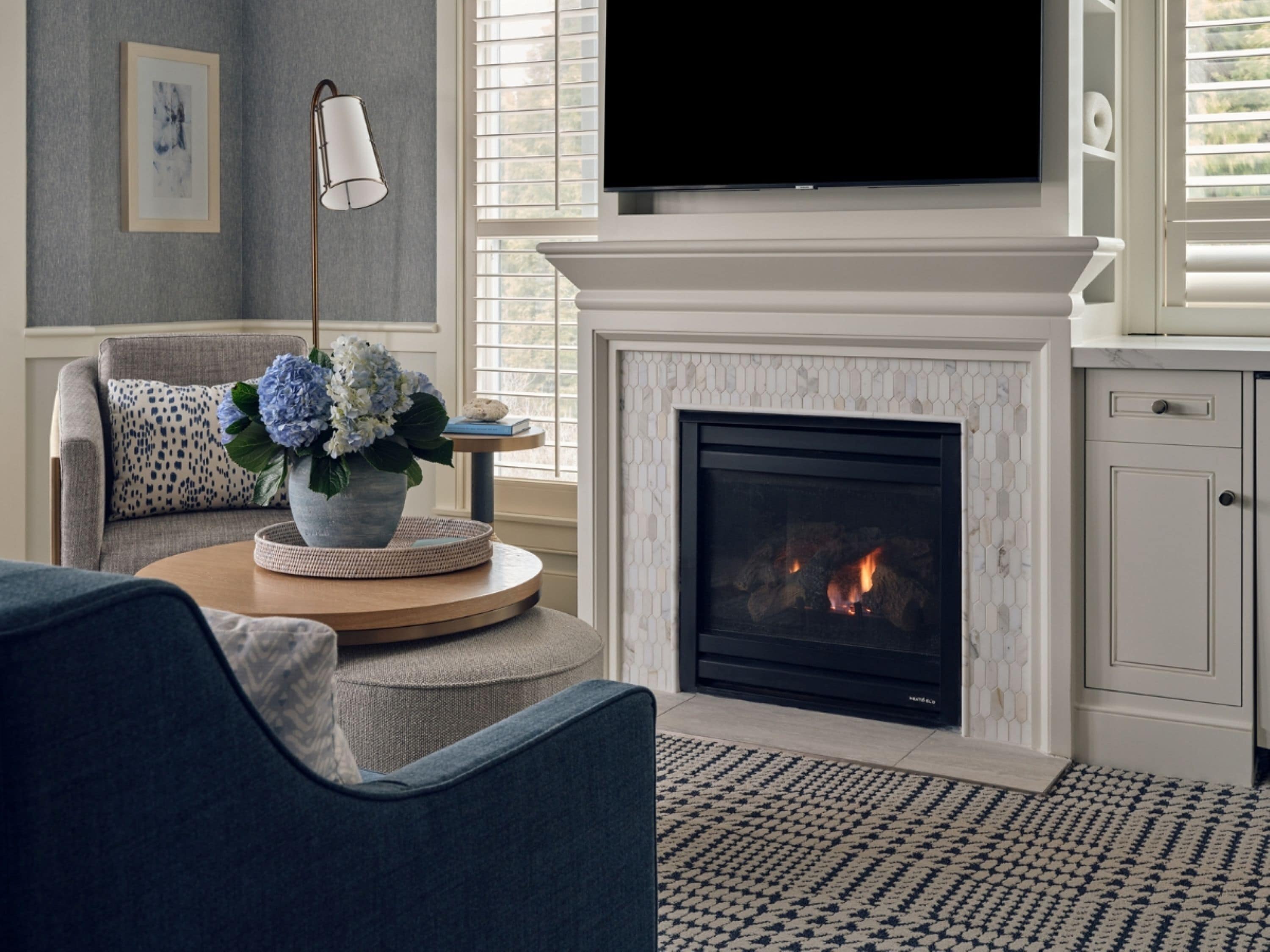 A living room with a fireplace, a television, and a sofa.