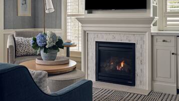 A living room with a fireplace, a television, and a sofa.