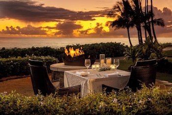 On the beach, beach umbrellas, beach massages at Sheraton Kauai Resort