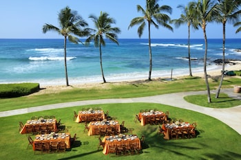 On the beach, beach umbrellas, beach massages at Sheraton Kauai Resort