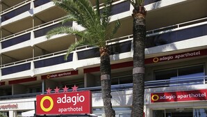 A multi-story building with balconies and a sign for Adagio Avarthotel. - Aparthotel Adagio Nice Promenade des Anglais (Nice)