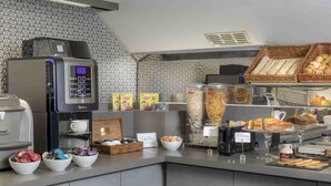 A breakfast bar with a coffee machine, cereal, and pastries. - Libertel Montmartre Opéra (Paris)