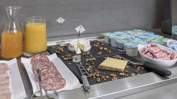 A breakfast buffet with various food items and beverages.