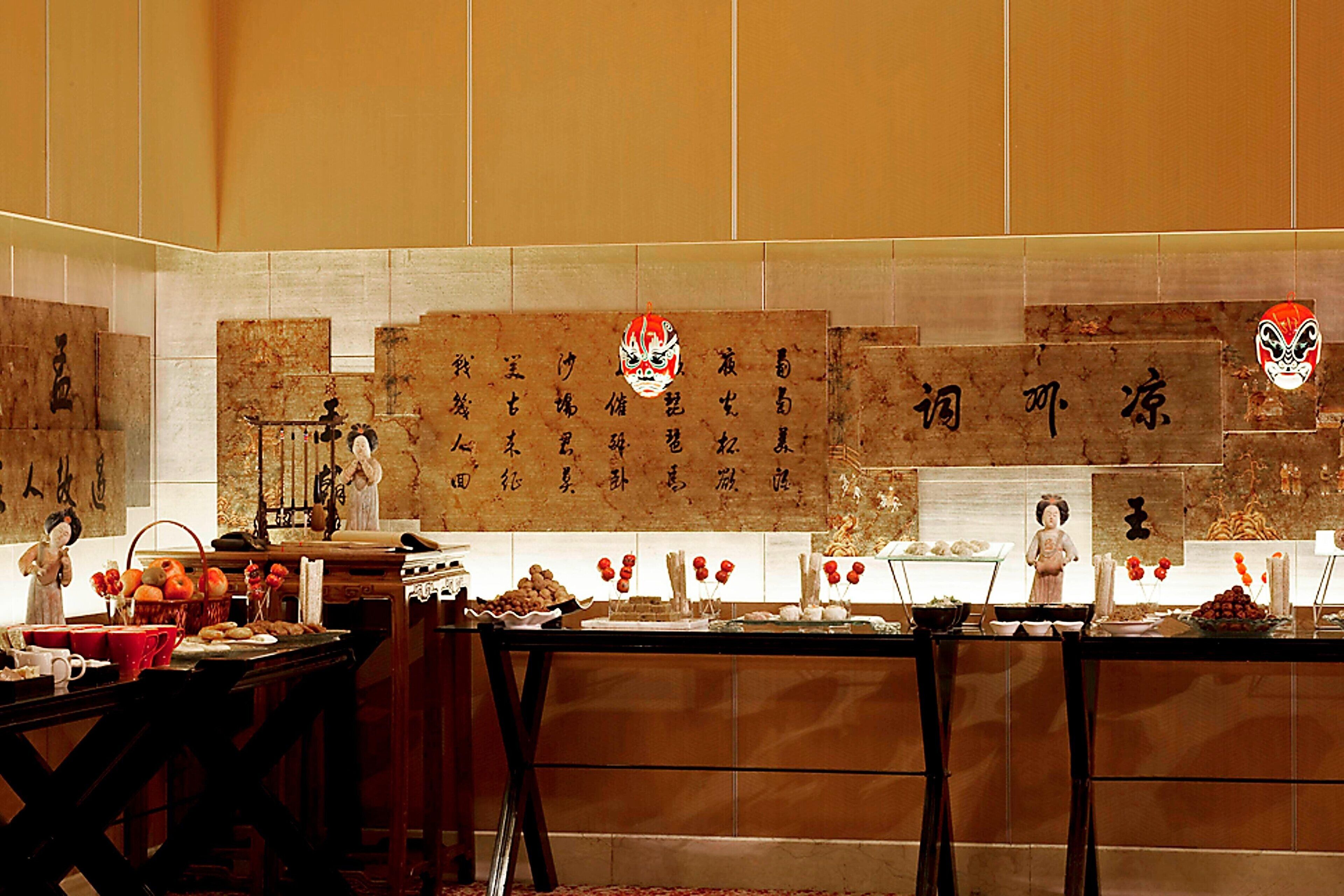A traditional Chinese restaurant interior with wooden tables, calligraphy on the walls, and traditional Chinese decorations.