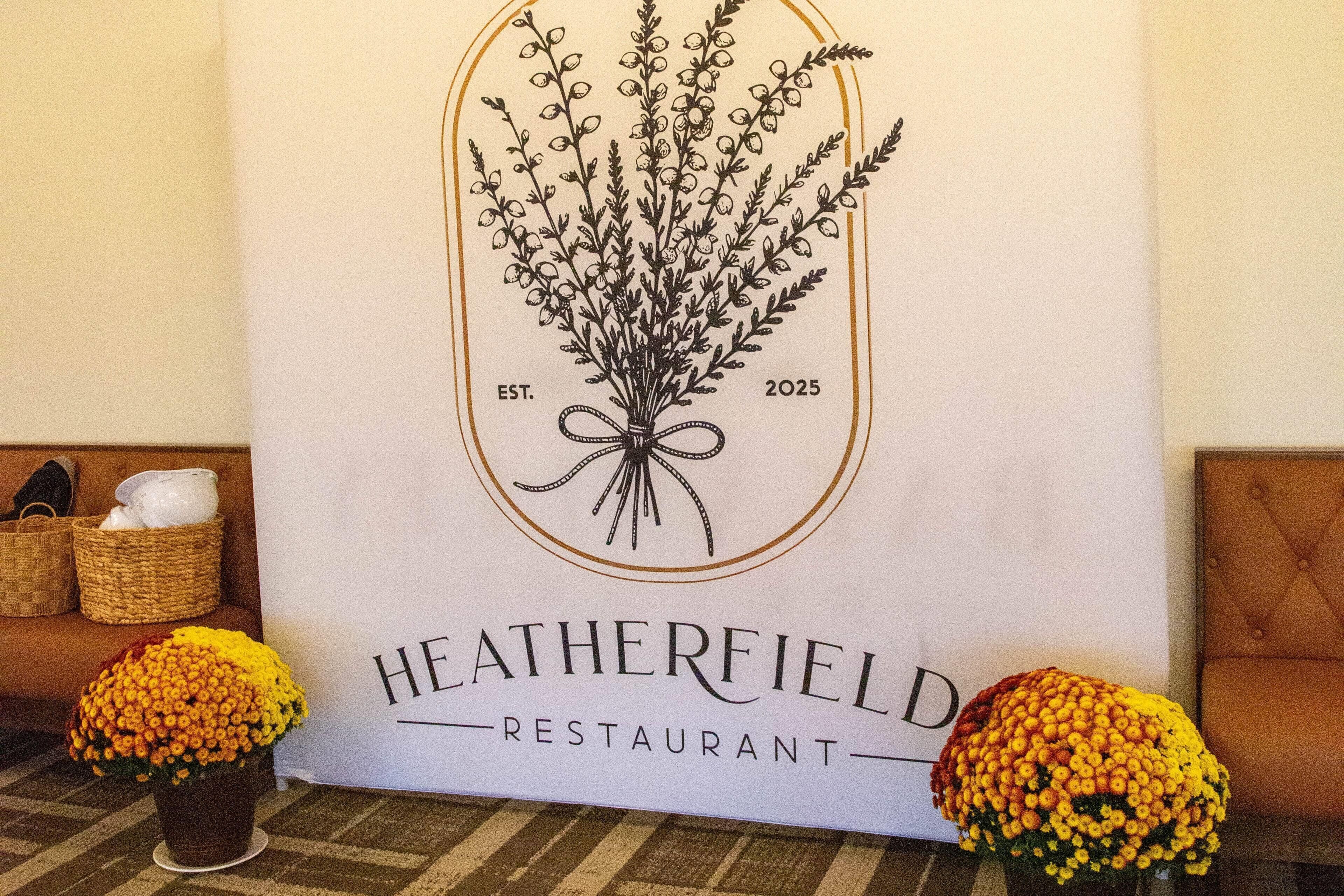 A restaurant sign with a plant illustration and the name "HEATHERFIELD RESTAURANT".