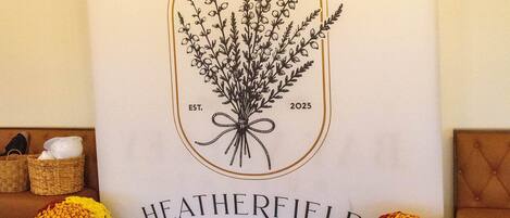 A restaurant sign with a plant illustration and the name "HEATHERFIELD RESTAURANT".