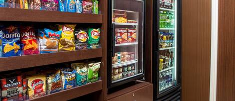 A snack and beverage vending area with various snack brands and a refrigerated section.