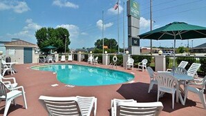 A pool area with lounge chairs and a sign for 'Culver's'.