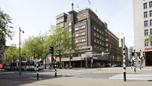 A multi-story building with a flat facade, a visible entrance, and a sign indicating it is the Atlanta Rotterdam.