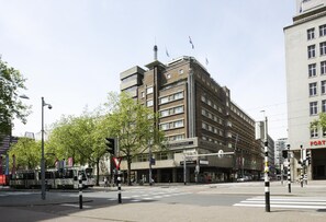A multi-story building with a flat facade, a visible entrance, and a sign indicating it is the Atlanta Rotterdam.