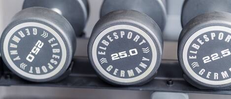 A set of weightlifting dumbbells labeled with weights and brand name.