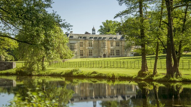 A large, historic building with a symmetrical facade, a central entrance, and a reflection in a calm water body in front. - Hartwell House & Spa (Aylesbury)