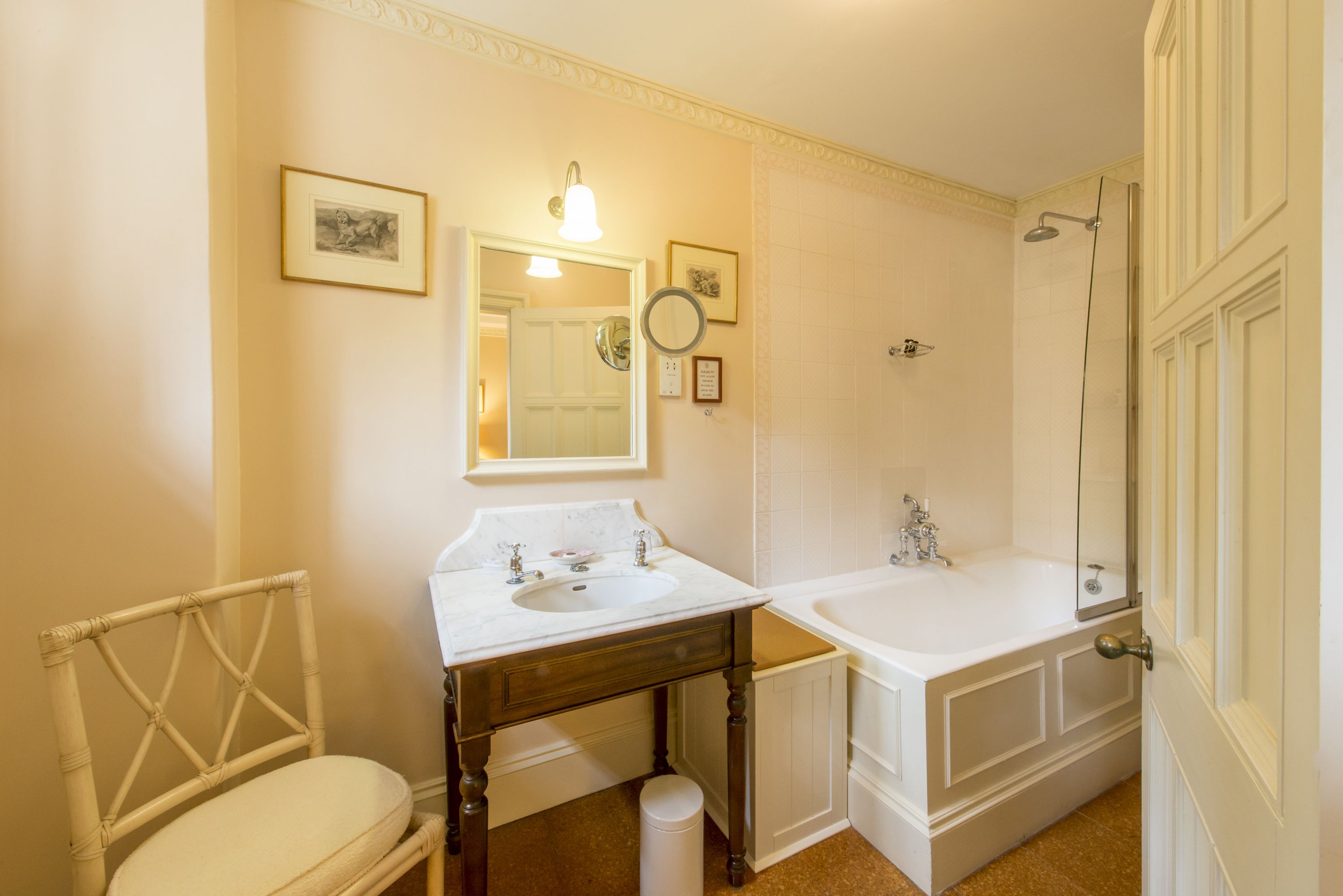 A bathroom with two sinks, a bathtub, a mirror, and a shower.