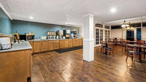 A spacious kitchen with wooden cabinets, a countertop, and a tiled backsplash.