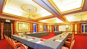 A conference room with a long table, chairs, and a red carpet. - The Royal Hotel Hull (Hull)
