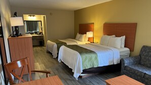 A hotel room with two beds, a desk, a chair, and a couch. - Quality Inn near Manatee Springs State Park (Chiefland)