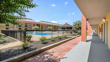 Guests can enjoy a clear view of the swimming pool from the hotel corridor.