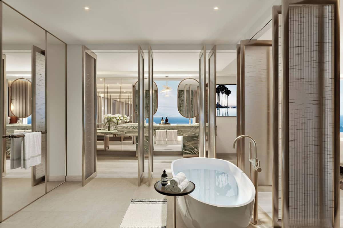 Relax in a spacious room with a bathtub and ocean view.