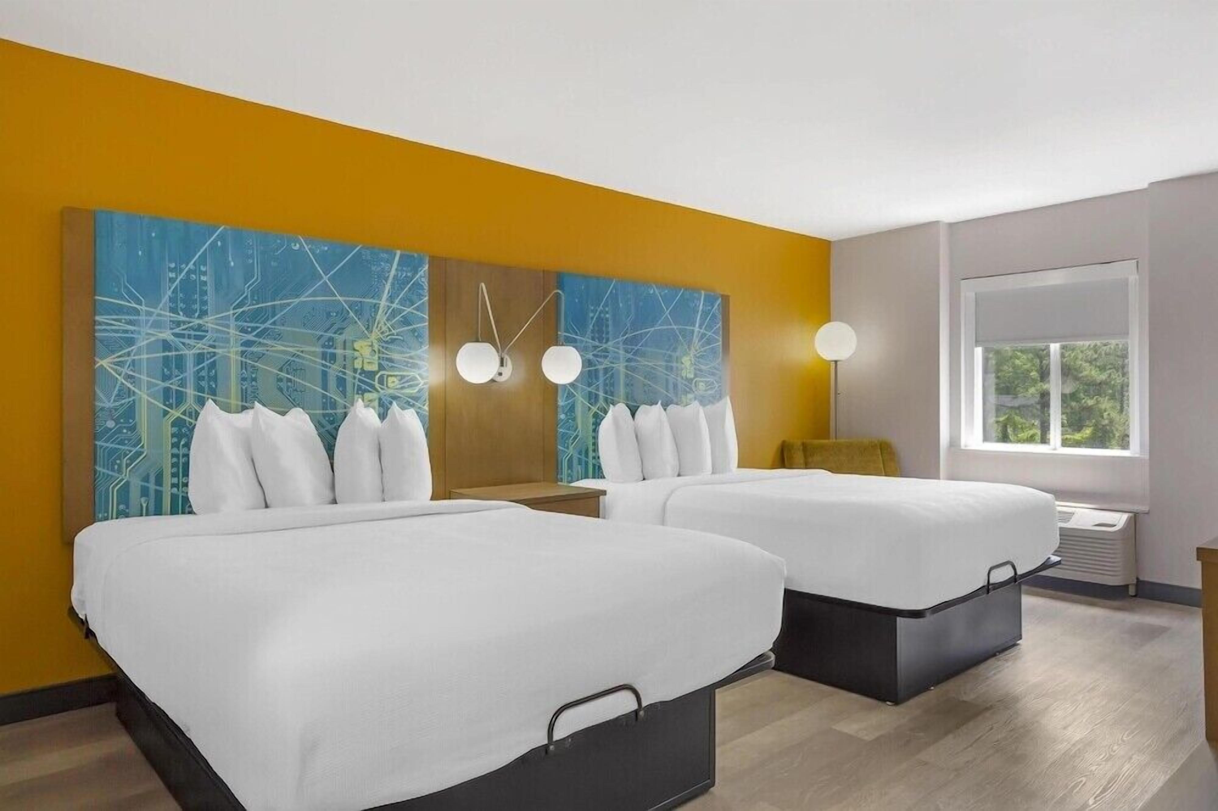 Premium bedding, pillow-top beds, desk, laptop workspace