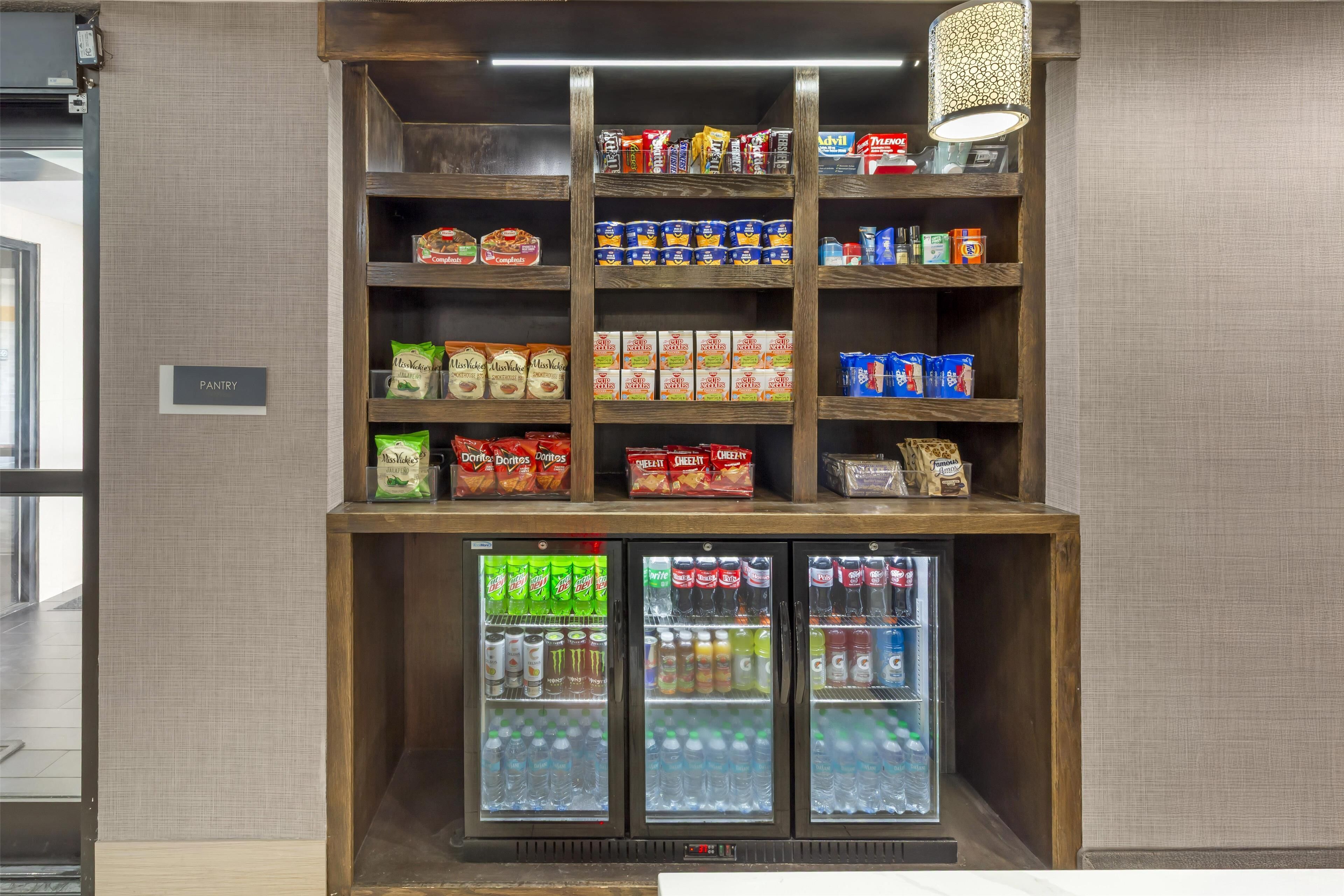 A pantry with shelves stocked with snacks, beverages, and packaged goods.