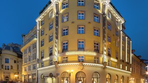 A historic building with multiple floors, large windows, and a prominent entrance. - Grand Hotel Bohemia (Prague)