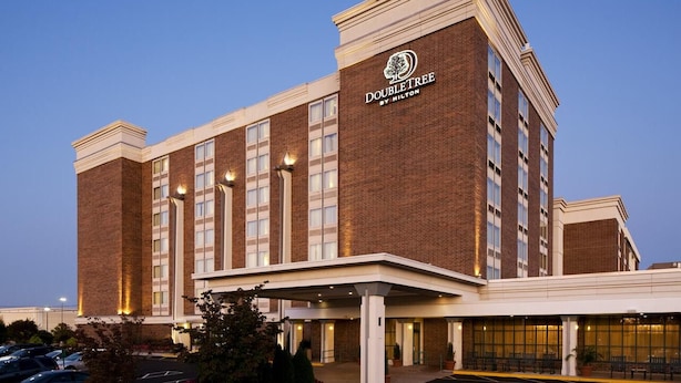 A DoubleTree by Hilton hotel with a brick facade, large windows, and a covered entrance area. - DoubleTree by Hilton Hotel Wilmington (Wilmington)