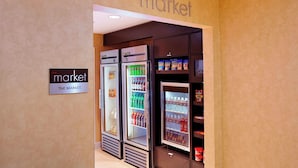 A refrigerated display case in a store with a sign reading "THE MARKET". - Residence Inn by Marriott San Antonio Downtown Market Square (San Antonio)