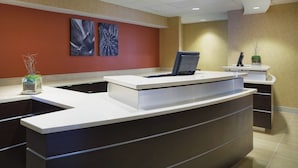 A reception desk with a computer, a vase with branches, and two abstract paintings on the wall. - Residence Inn by Marriott San Antonio Downtown Market Square (San Antonio)