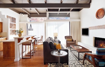 A reception area with a long wooden reception desk, stone wall, and a view of the outdoors. at Enchantment