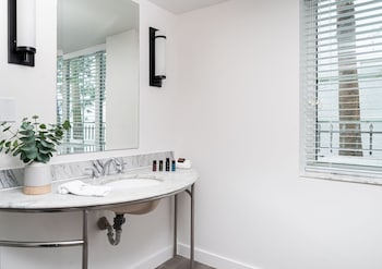 Combined shower/tub, designer toiletries, hair dryer, towels at Essex House By Clevelander