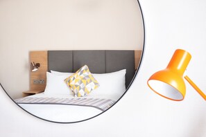 Hypo-allergenic bedding, desk, laptop workspace, blackout curtains