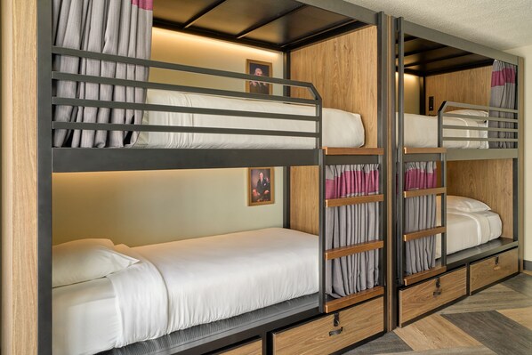 A bunk bed room with wooden walls, a small desk, and a picture on the wall. - Hotel Rendale Washington DC (Washington)