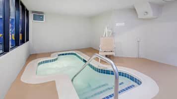 A spa area with two hot tubs and a massage chair.