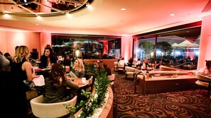 Un restaurant doté d’une salle à manger intérieure, d’un bar et de grandes fenêtres donnant sur l’extérieur.