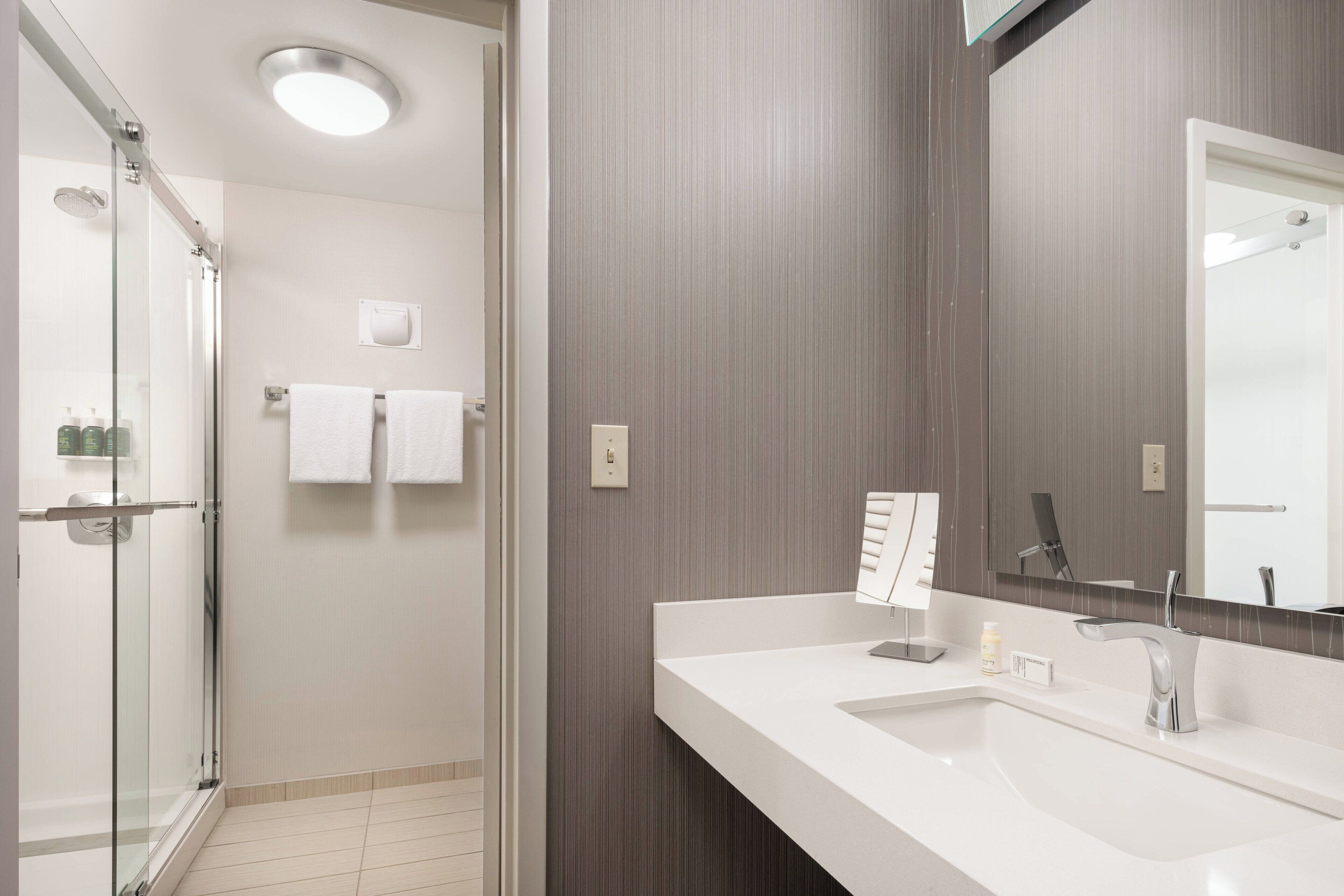 combined shower/bathtub, designer toiletries, hair dryer, towels