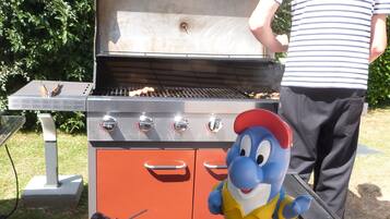 A barbecue grill with a mascot and a plate of food.