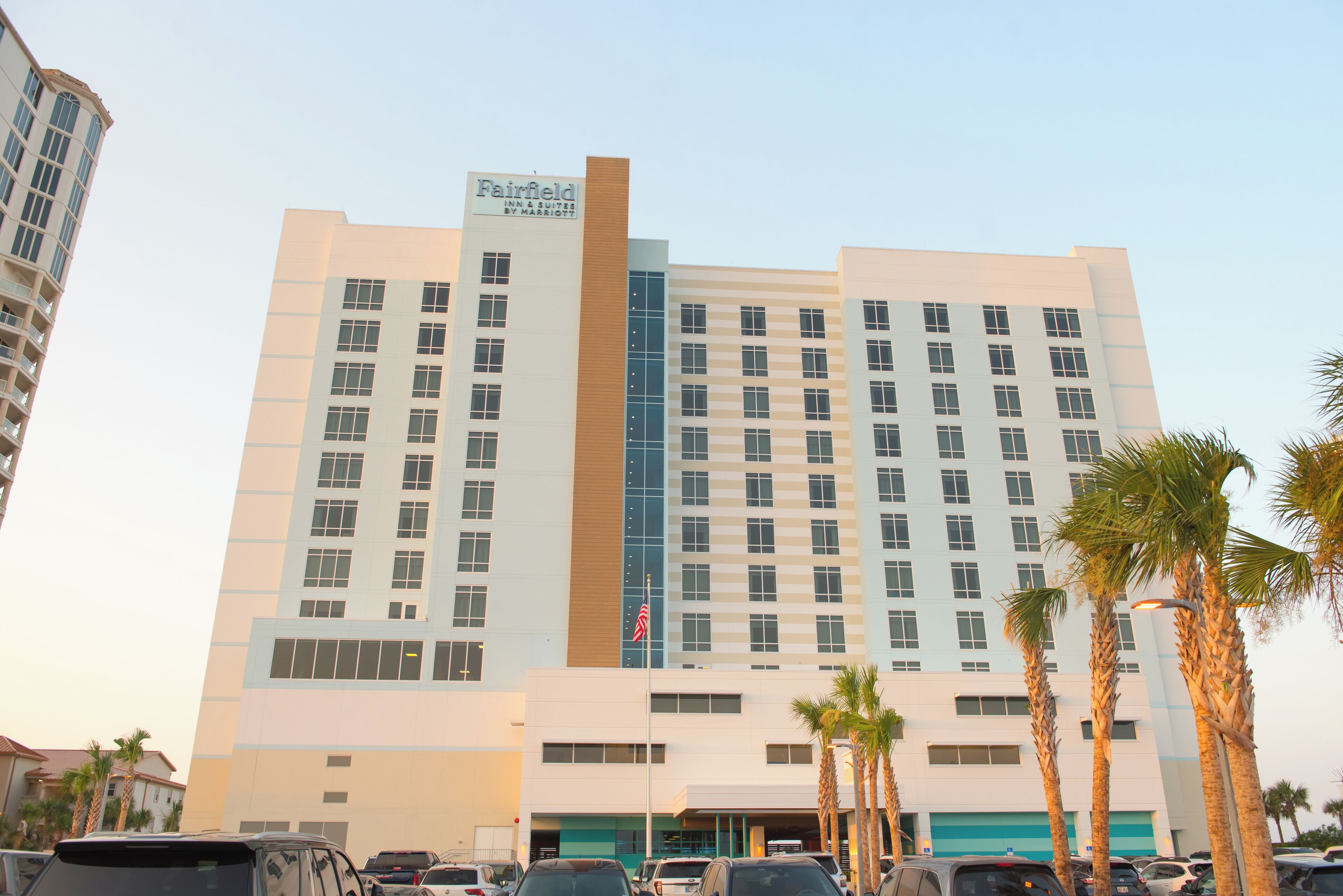 A multi-story hotel with a prominent sign for Fairfield Inn & Suites by Marriott.
