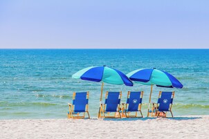 On the beach, white sand, beach towels, beach bar