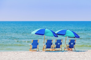 On the beach, white sand, sun-loungers, beach umbrellas