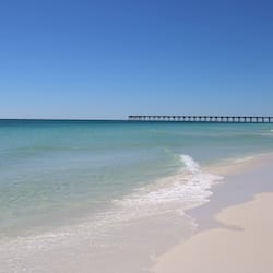 On the beach, white sand, sun loungers, beach umbrellas