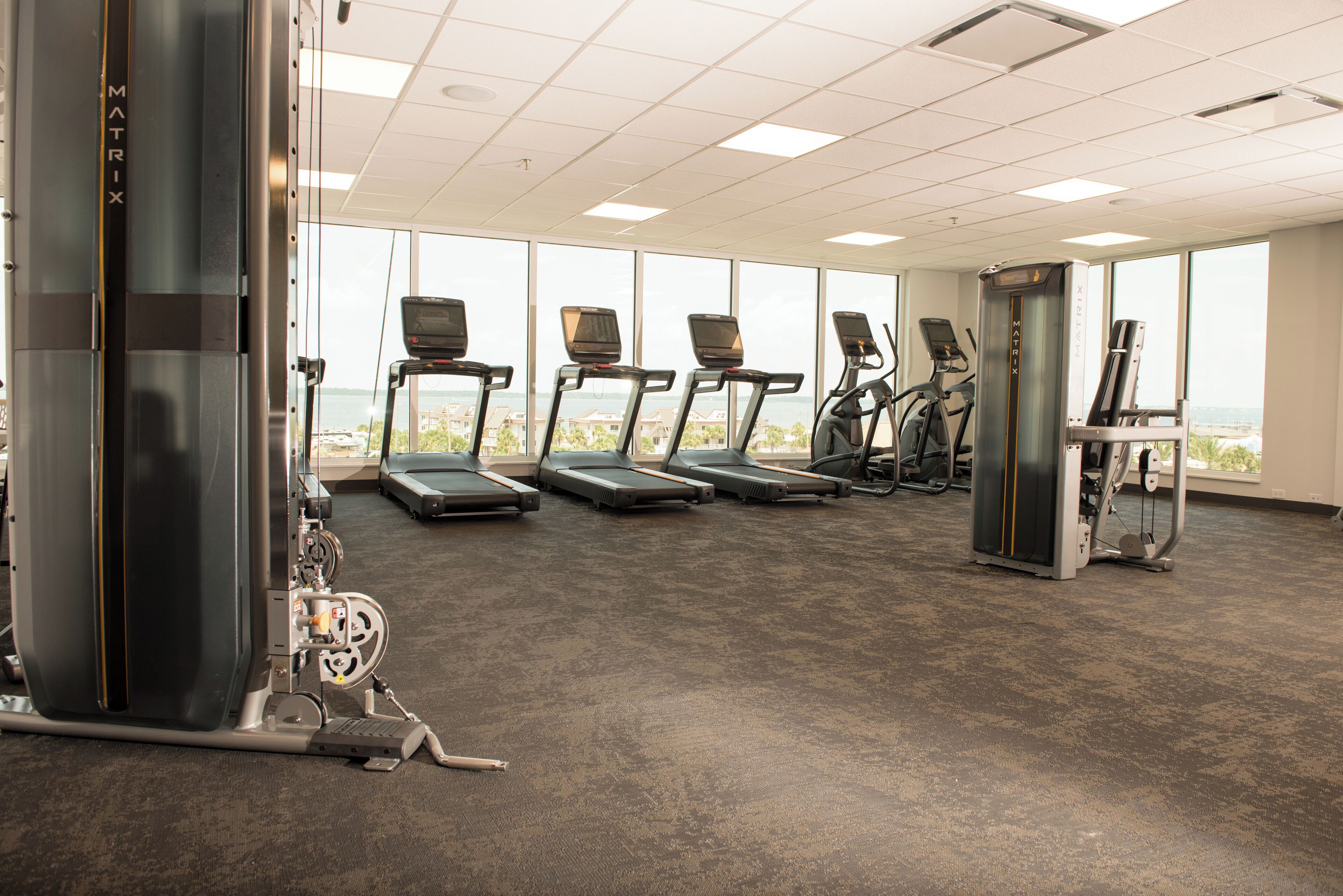 A gym with treadmills, a stationary bike, and a weight machine.