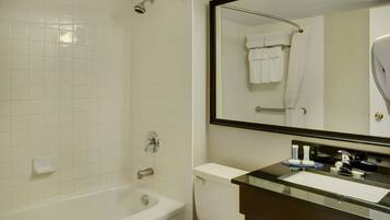 A bathroom with a bathtub, toilet, and sink.