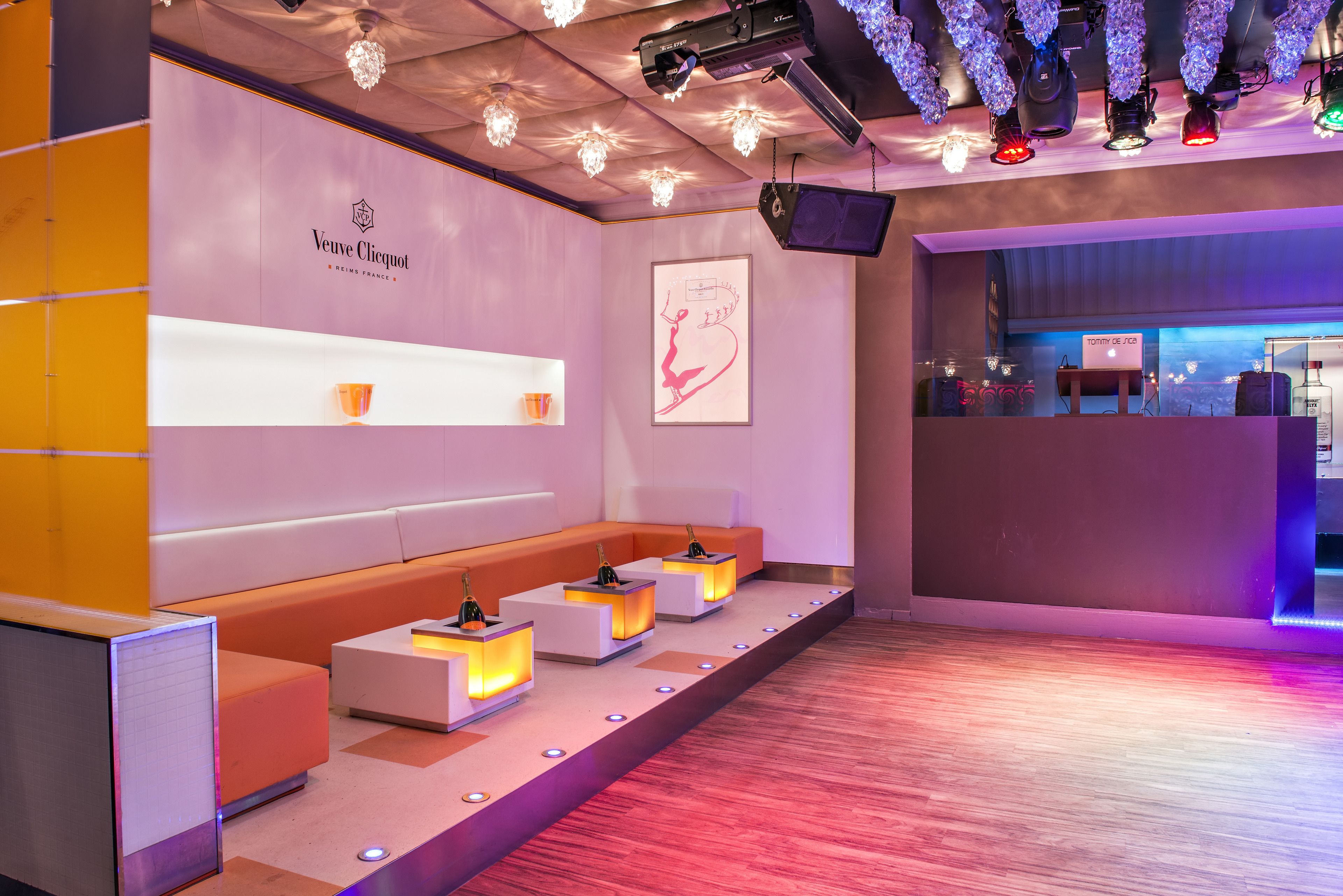 A modern lounge area with seating and a bar area.