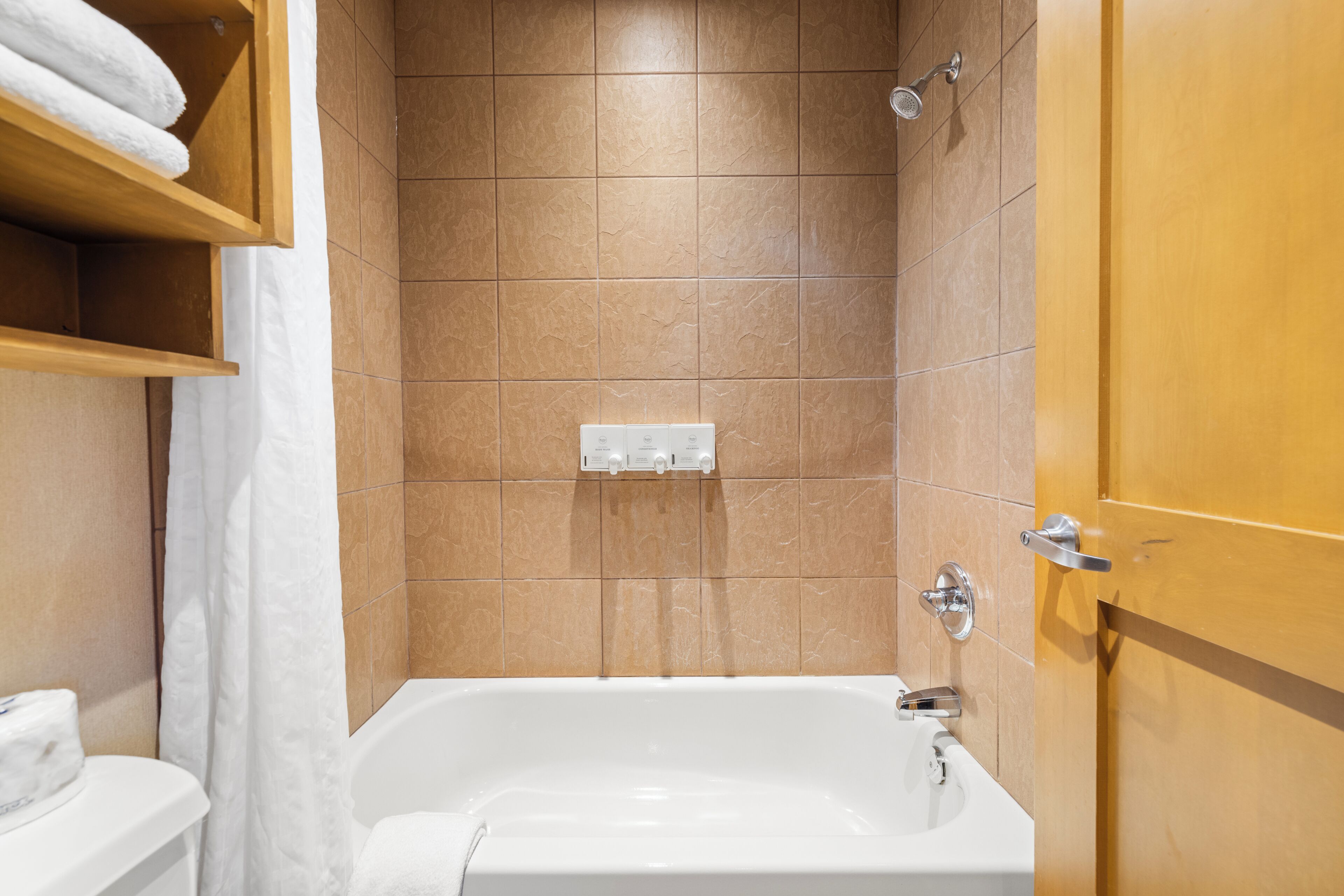 A bathroom with a bathtub, a shower, and a toilet.