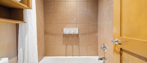 A bathroom with a bathtub, a shower, and a toilet.